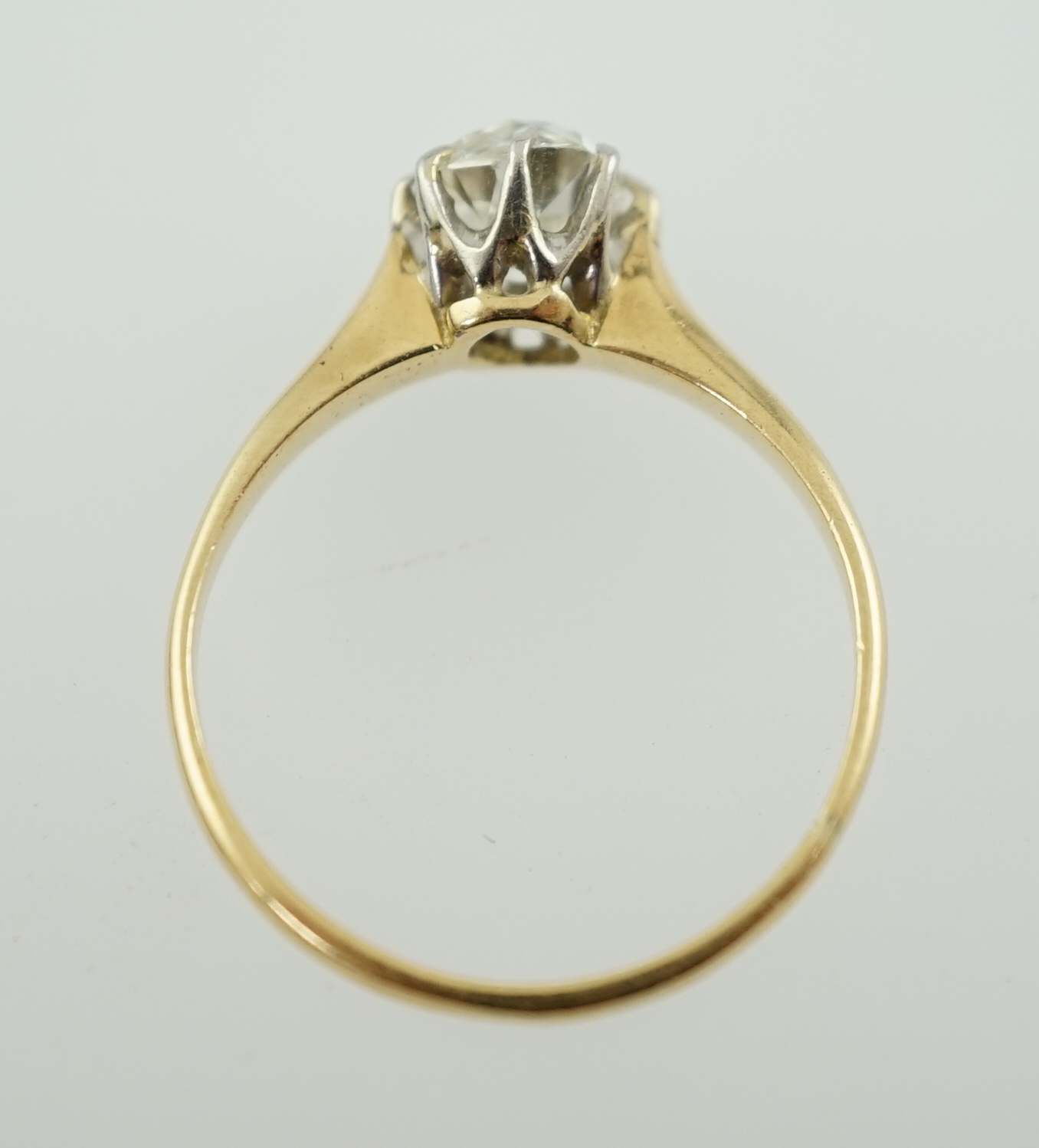 A gold and cushion cut solitaire diamond set ring